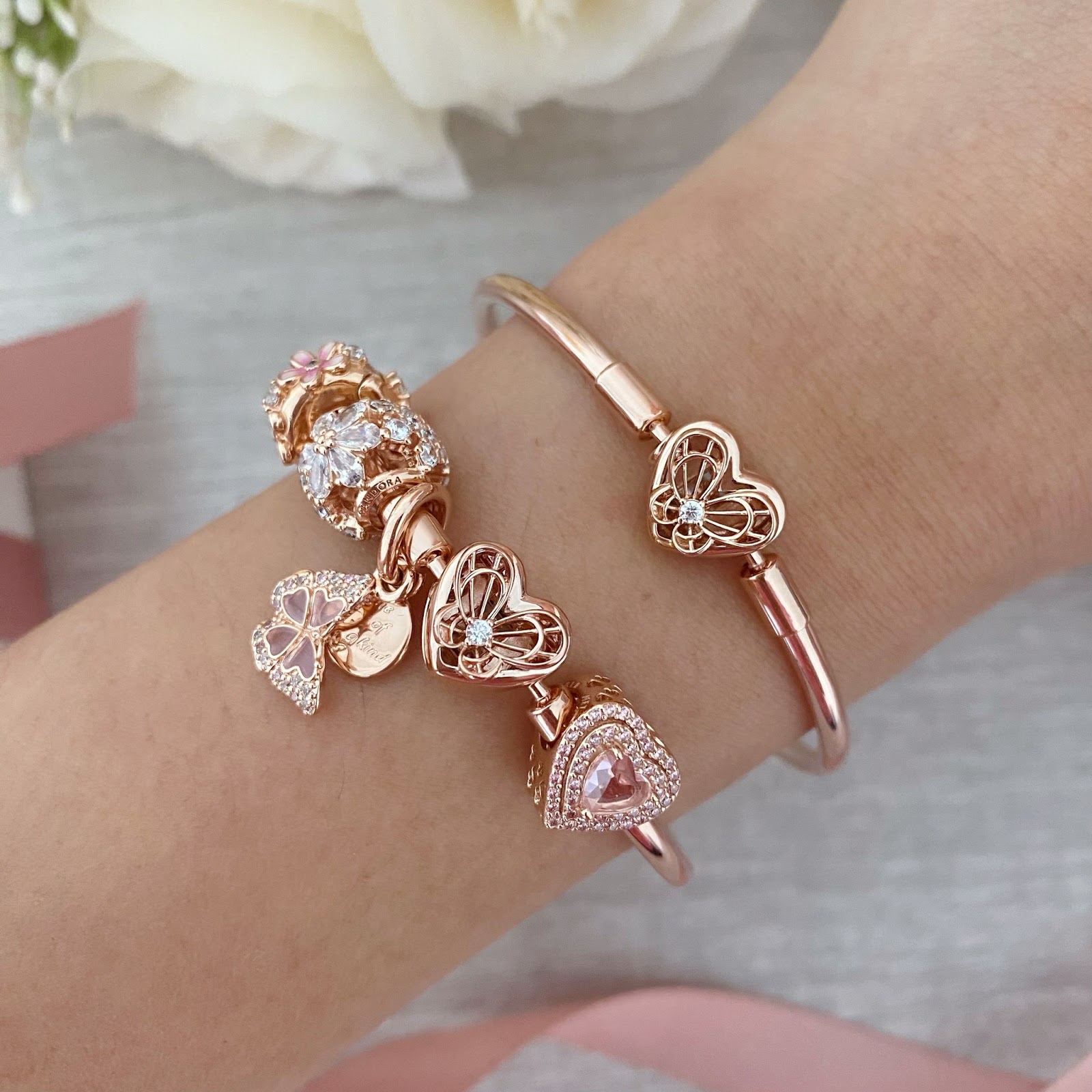 Pink gold Pandora bangle laced with heart shaped charms